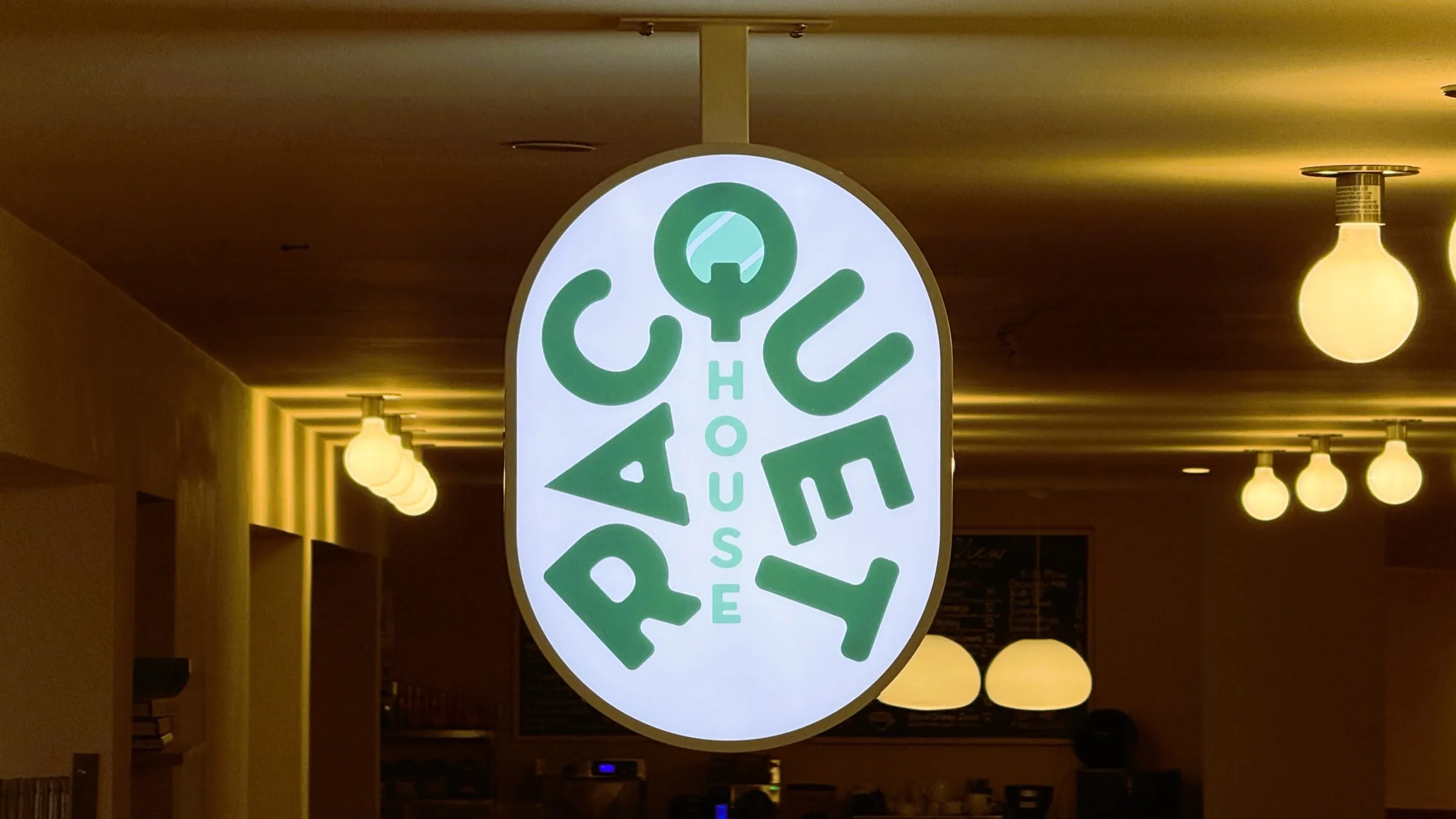 The illuminated Racquet House sign glowing inside CityView Racquet Club