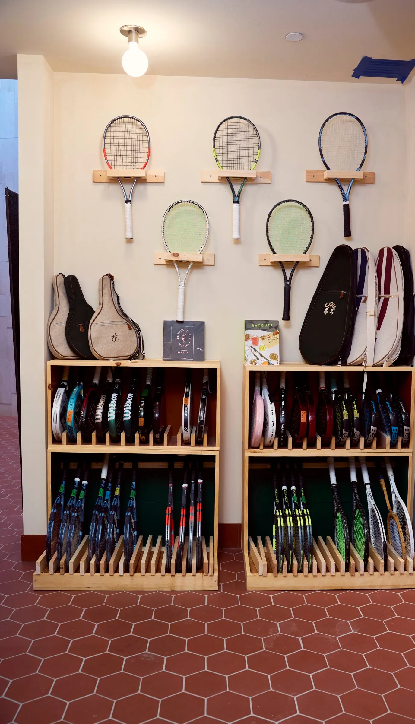 The demo-racquet wall and racks inside the pro shop